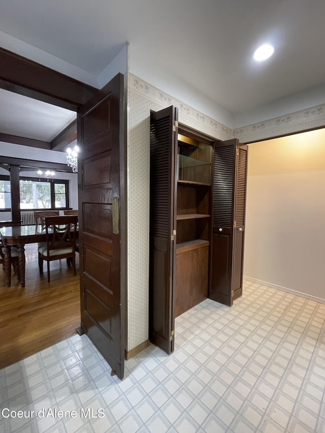 6990 Denver St, Bonners Ferry, ID 83805 - interior space with baseboards, light floors, an inviting chandelier, and wallpapered walls