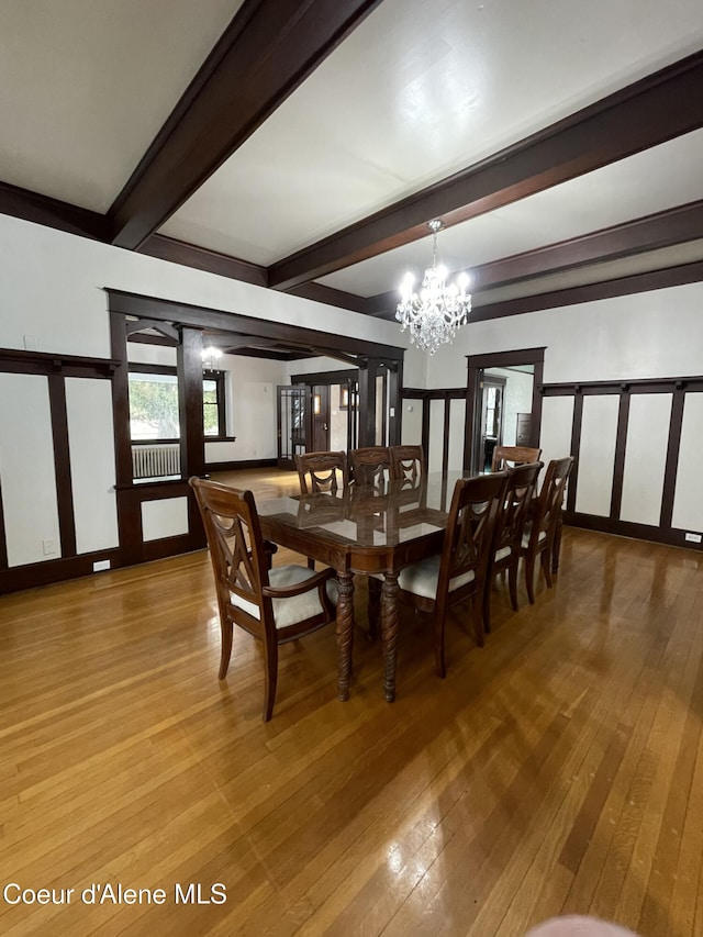 6990 Denver St, Bonners Ferry, ID 83805 - dining space with an inviting chandelier, light wood finished floors, and beam ceiling