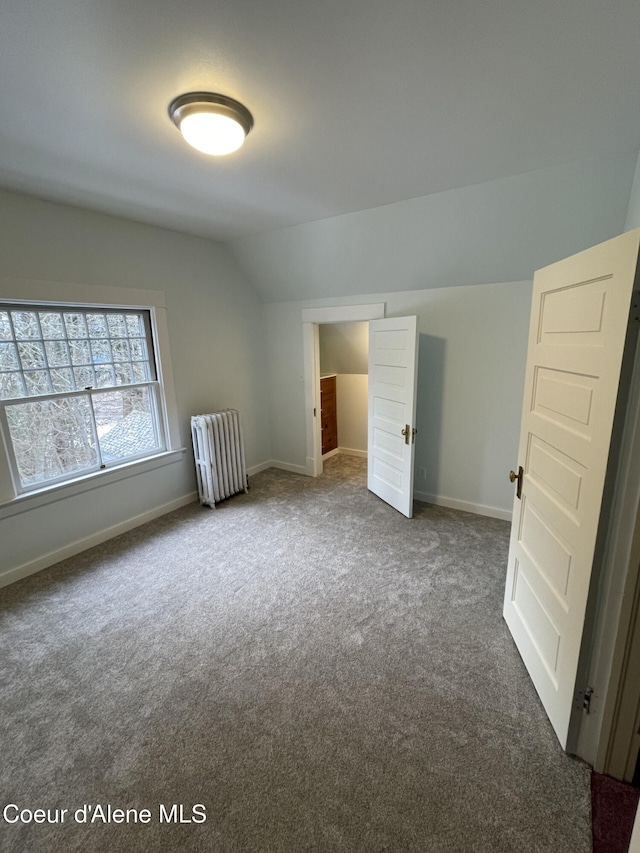 6990 Denver St, Bonners Ferry, ID 83805 - additional living space featuring radiator heating unit, carpet floors, baseboards, and lofted ceiling
