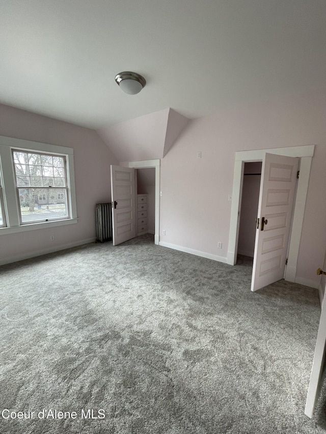 6990 Denver St, Bonners Ferry, ID 83805 - unfurnished bedroom featuring radiator heating unit, carpet floors, baseboards, and lofted ceiling