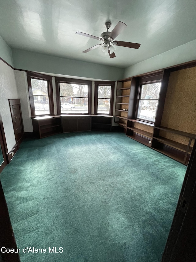6990 Denver St, Bonners Ferry, ID 83805 - empty room with carpet, ceiling fan, and a wealth of natural light