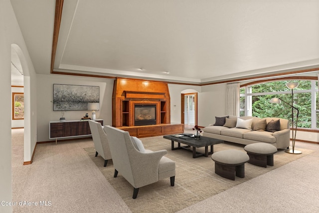 1358 S Starlight Dr, Coeur Dalene, ID 83814 - living area with light colored carpet, arched walkways, a raised ceiling, and baseboards