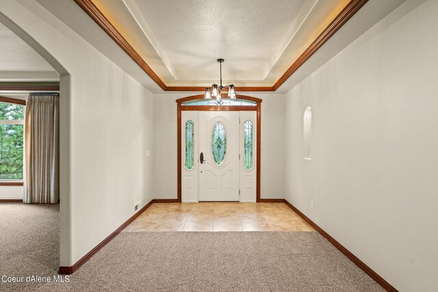 1358 S Starlight Dr, Coeur Dalene, ID 83814 - foyer entrance with arched walkways, baseboards, light carpet, and a tray ceiling
