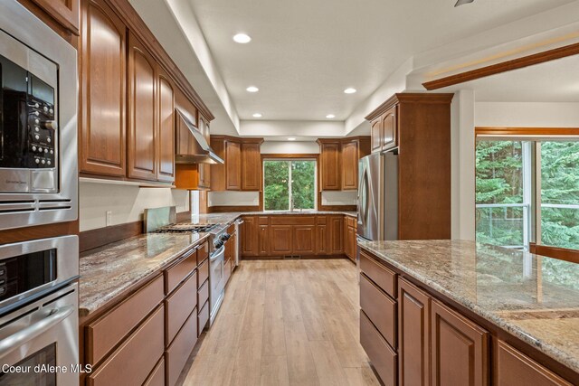 1358 S Starlight Dr, Coeur Dalene, ID 83814 - kitchen featuring light stone countertops, ventilation hood, light wood-style floors, stainless steel appliances, and recessed lighting