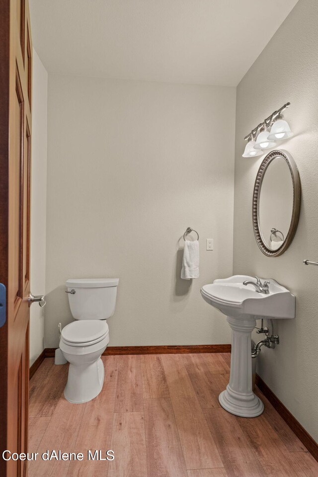 1358 S Starlight Dr, Coeur Dalene, ID 83814 - bathroom featuring toilet, baseboards, and wood finished floors
