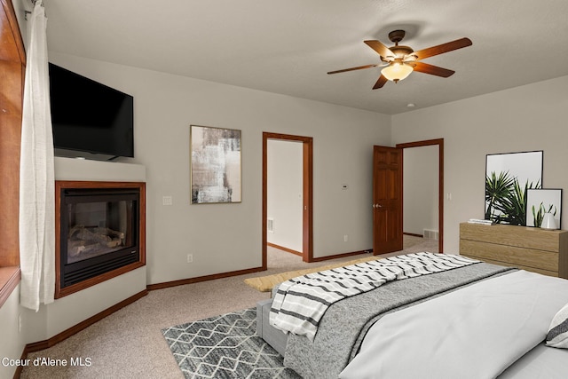 1358 S Starlight Dr, Coeur Dalene, ID 83814 - carpeted bedroom with a glass covered fireplace, baseboards, a ceiling fan, and visible vents