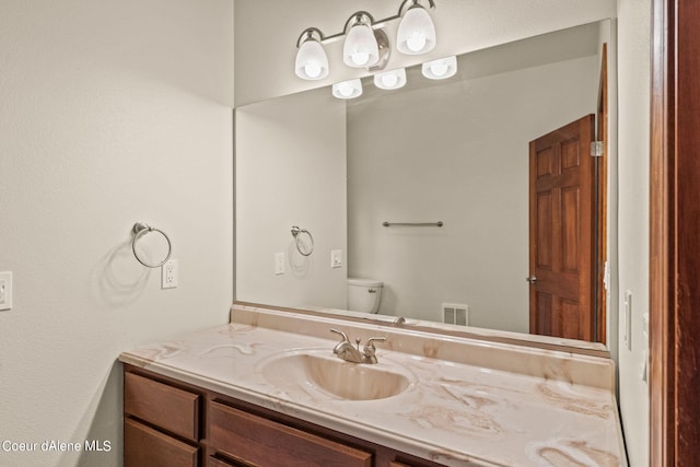 1358 S Starlight Dr, Coeur Dalene, ID 83814 - bathroom featuring visible vents, toilet, and vanity