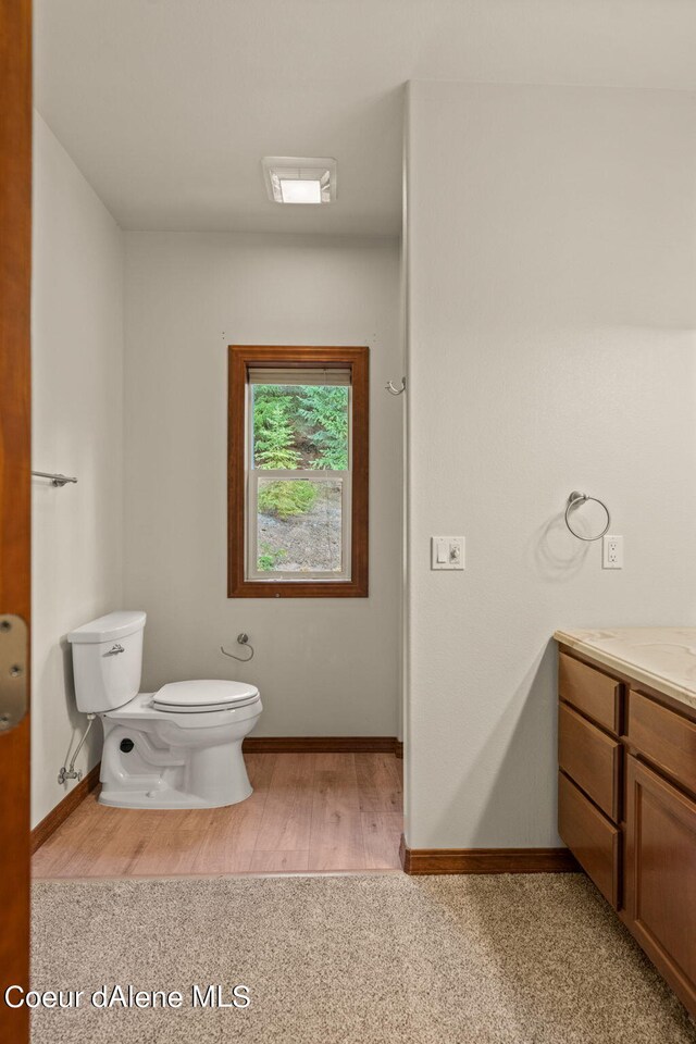 1358 S Starlight Dr, Coeur Dalene, ID 83814 - bathroom with baseboards, vanity, toilet, and wood finished floors
