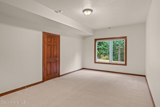 1358 S Starlight Dr, Coeur Dalene, ID 83814 - spare room featuring light colored carpet, a textured ceiling, baseboards, and visible vents