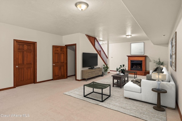 1358 S Starlight Dr, Coeur Dalene, ID 83814 - living area featuring baseboards, a fireplace with raised hearth, and light colored carpet