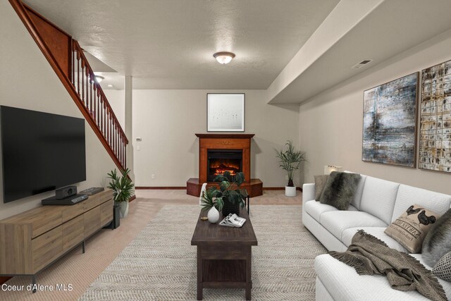 1358 S Starlight Dr, Coeur Dalene, ID 83814 - living room featuring stairway, baseboards, a warm lit fireplace, and light colored carpet