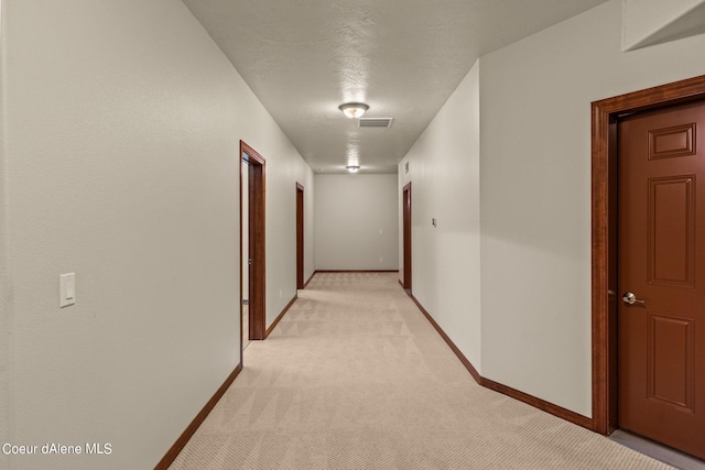 1358 S Starlight Dr, Coeur Dalene, ID 83814 - corridor featuring baseboards, visible vents, and light carpet