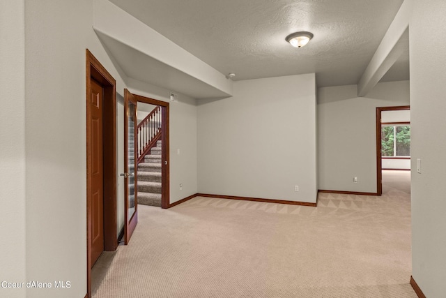1358 S Starlight Dr, Coeur Dalene, ID 83814 - spare room featuring baseboards, light carpet, stairs, and a textured ceiling