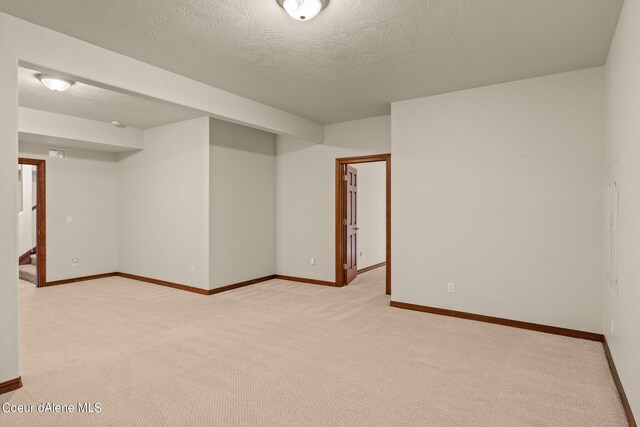 1358 S Starlight Dr, Coeur Dalene, ID 83814 - unfurnished room with a textured ceiling, baseboards, and light carpet