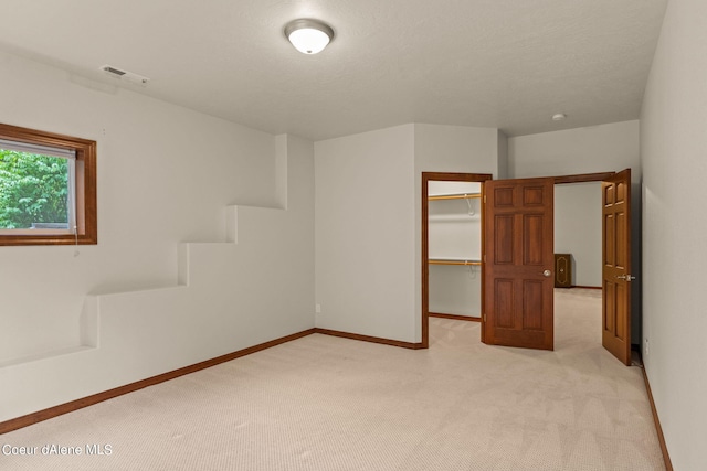 1358 S Starlight Dr, Coeur Dalene, ID 83814 - interior space with light colored carpet, a walk in closet, baseboards, visible vents, and a closet