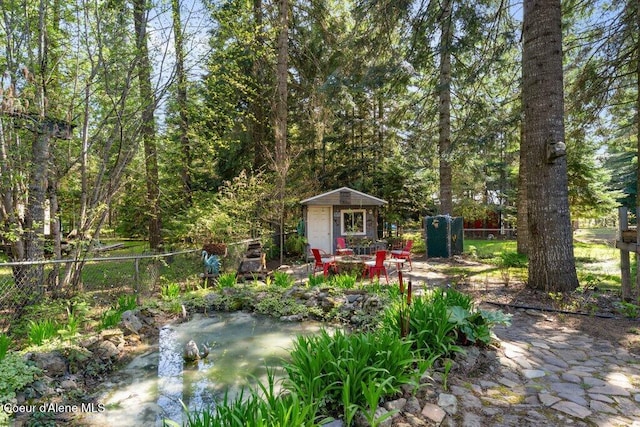 view of yard with fence and an outdoor structure