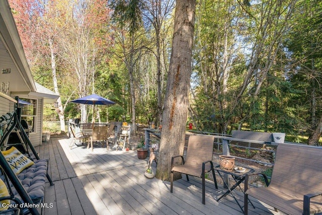 wooden deck featuring outdoor dining area