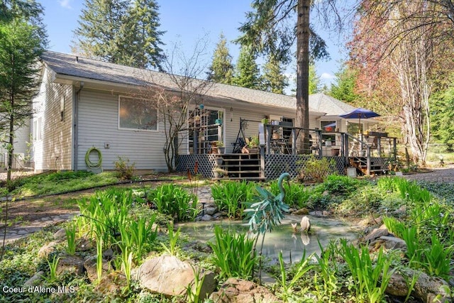 back of house featuring a wooden deck