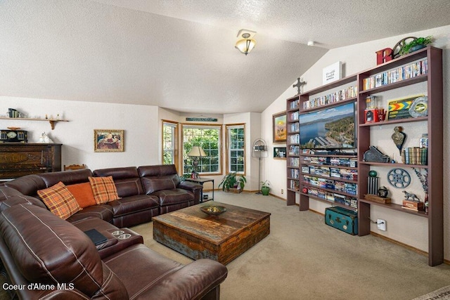 carpeted living room with baseboards, a textured ceiling, and lofted ceiling