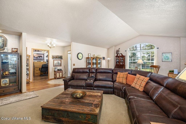 living area featuring carpet flooring, a textured ceiling, a chandelier, and lofted ceiling