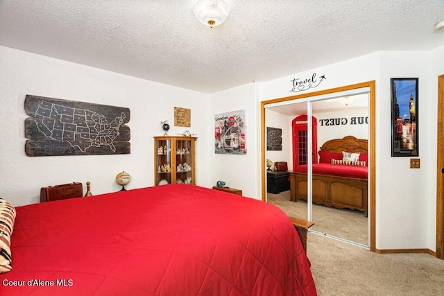 carpeted bedroom with baseboards, a closet, and a textured ceiling