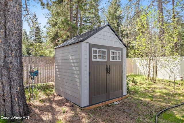 view of shed with a fenced backyard