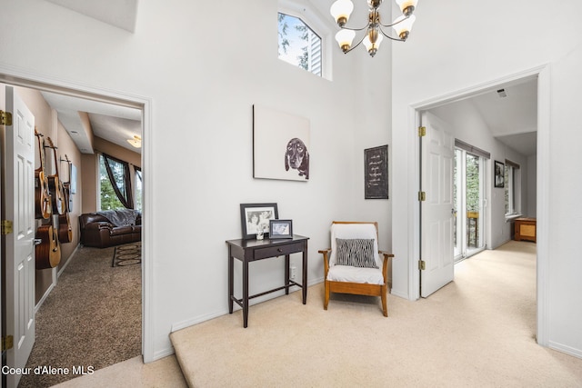 sitting room featuring baseboards, carpet, and a chandelier