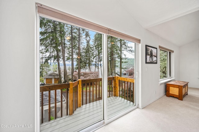 entryway featuring baseboards, carpet flooring, and lofted ceiling