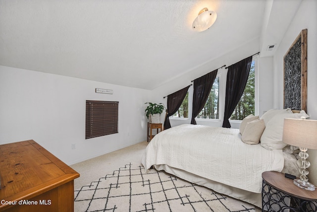 bedroom with baseboards, visible vents, and light carpet