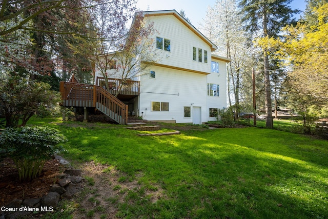 back of property featuring stairs, a yard, and a deck