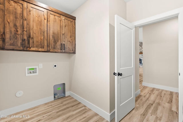 washroom with cabinet space, electric dryer hookup, light wood-style flooring, and hookup for a washing machine