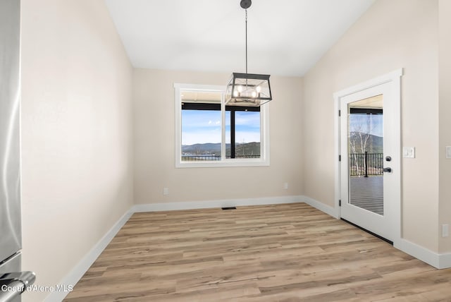 unfurnished dining area with baseboards, plenty of natural light, and light wood-style flooring