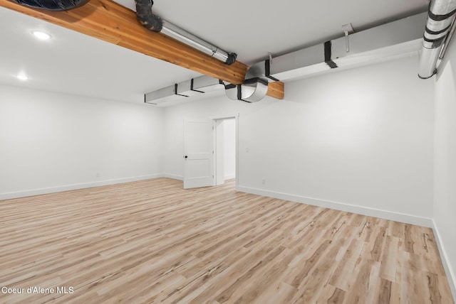 garage with recessed lighting and baseboards