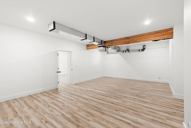 finished basement featuring baseboards, recessed lighting, and wood finished floors
