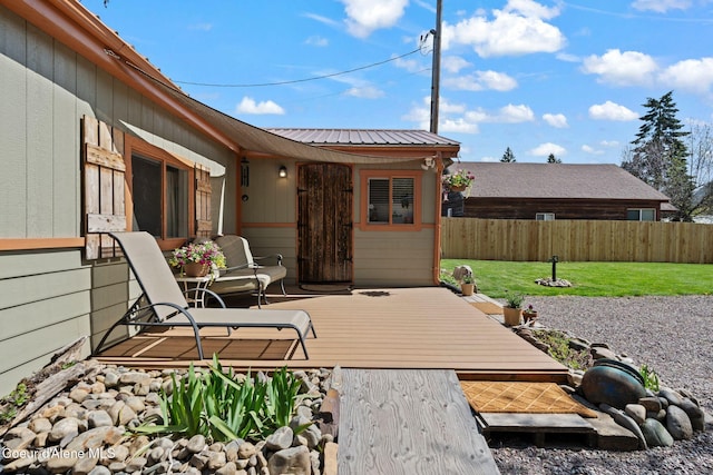 view of patio with fence and a wooden deck