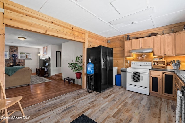 kitchen featuring black refrigerator with ice dispenser, open floor plan, light wood-type flooring, under cabinet range hood, and electric stove