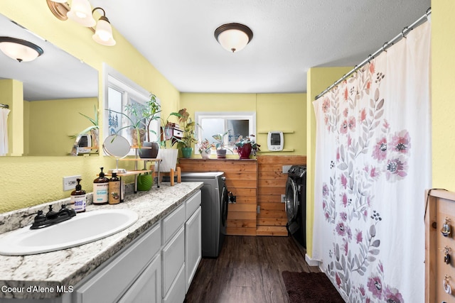 full bathroom with vanity, a shower with curtain, wood finished floors, and washing machine and clothes dryer