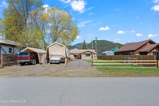 exterior space featuring a mountain view and fence