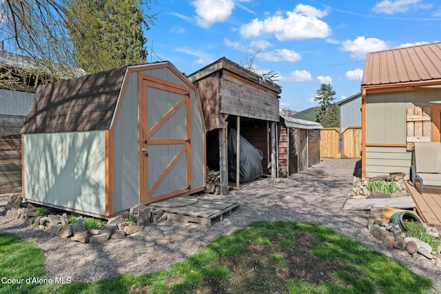 view of shed featuring fence