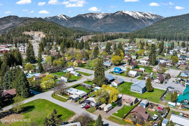 birds eye view of property featuring a residential view, a view of trees, and a mountain view