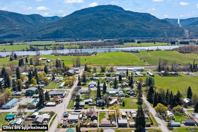 aerial view featuring a rural view and a water and mountain view