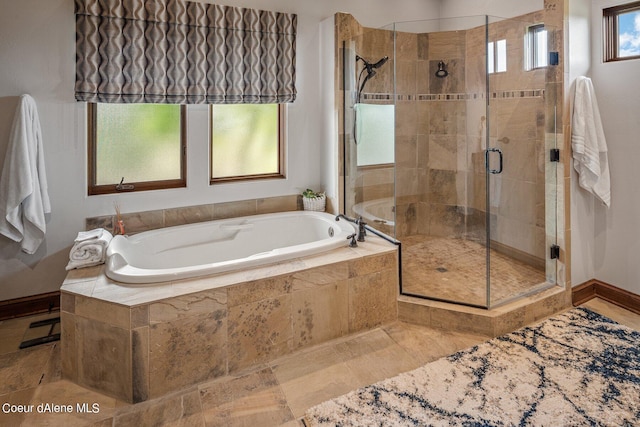 full bath with baseboards, a shower stall, and a bath