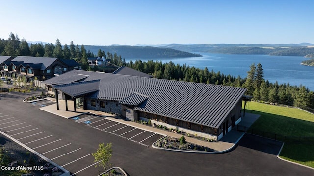 birds eye view of property with a water and mountain view