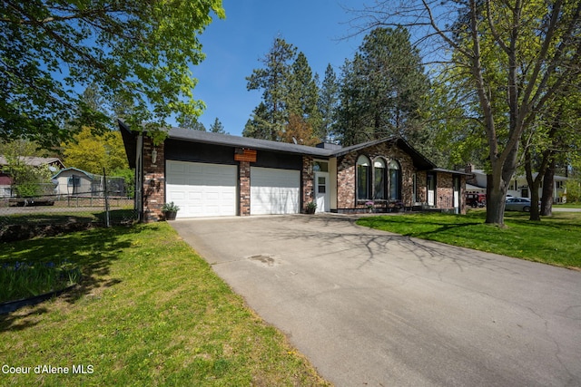 211 S Pinewood Dr, Post Falls, ID 83854 - view of front of home featuring fence, a front lawn, brick siding, a garage, and driveway