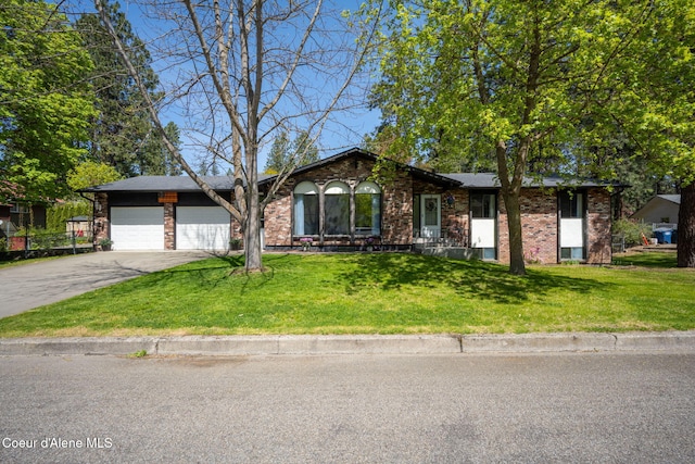 211 S Pinewood Dr, Post Falls, ID 83854 - single story home featuring an attached garage, driveway, brick siding, and a front yard