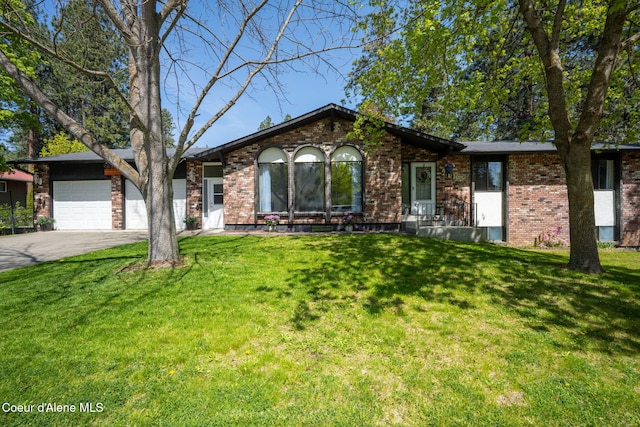 211 S Pinewood Dr, Post Falls, ID 83854 - ranch-style house featuring an attached garage, concrete driveway, a front lawn, and brick siding