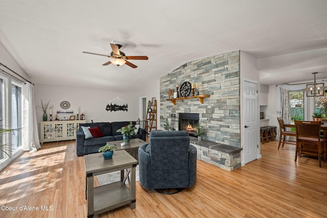 211 S Pinewood Dr, Post Falls, ID 83854 - living area with ceiling fan, wood finished floors, lofted ceiling, and a fireplace