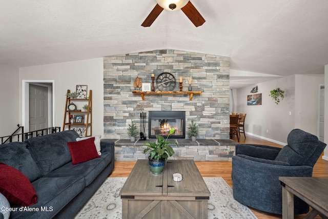 211 S Pinewood Dr, Post Falls, ID 83854 - living area featuring ceiling fan, a fireplace, baseboards, wood finished floors, and lofted ceiling