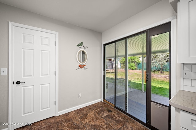 211 S Pinewood Dr, Post Falls, ID 83854 - doorway featuring baseboards, stone finish flooring, and a wealth of natural light