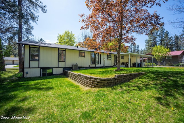 211 S Pinewood Dr, Post Falls, ID 83854 - back of house with a lawn, central air condition unit, and fence